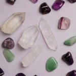 Flat lay arrangement of diverse crystals, showcasing various colors and textures.